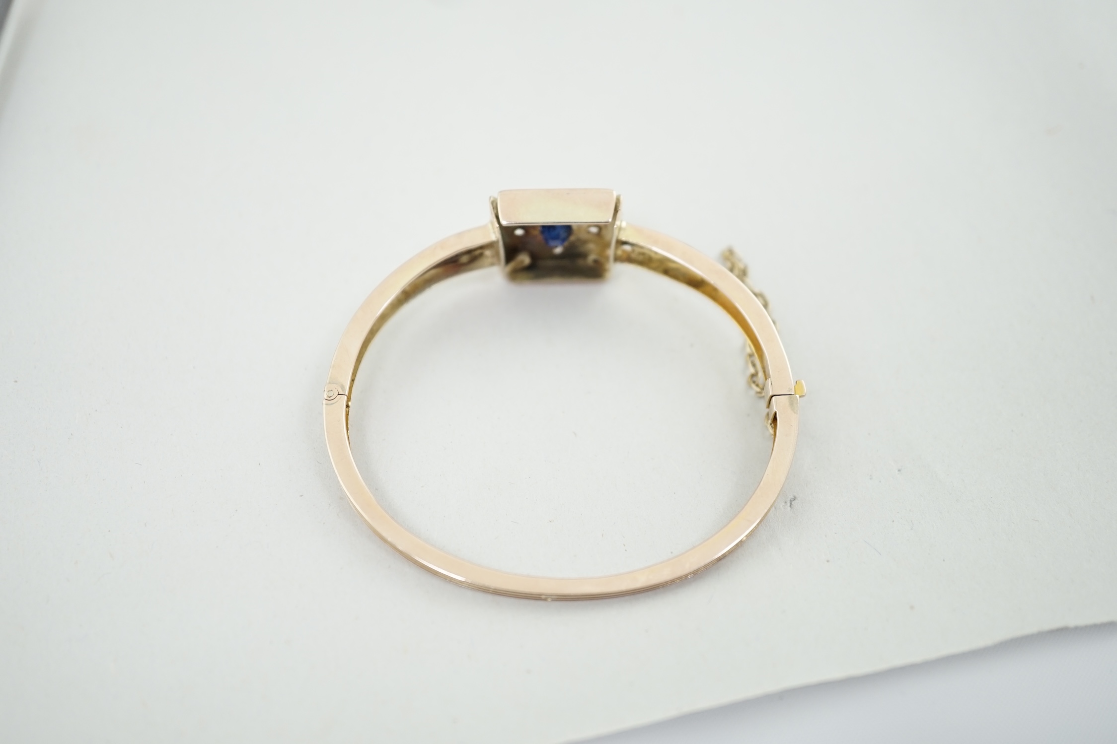 A Victorian gold, single stone sapphire and four stone diamond set hinged bracelet